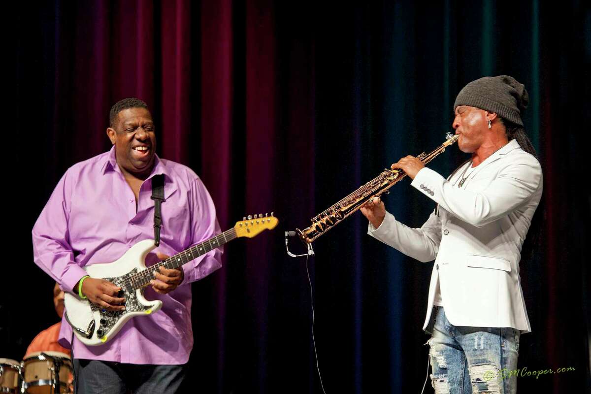 The late Rohn Lawrence, left, plays guitar with smooth jazz saxophone player Marion Meadows, right, at the Milford Performance Center.