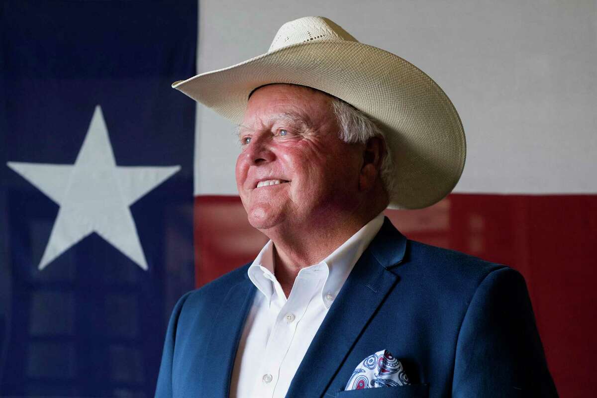 Texas Agriculture Commissioner Sid Miller stands in front of a Texas flag at Renard Group Advertising in Tyler, Texas, Thursday, July 12, 2018. Miller came to Tyler to speak to local agricultural leaders about the state of the Texas agricultural community. (Chelsea Purgahn/Tyler Morning Telegraph via AP)