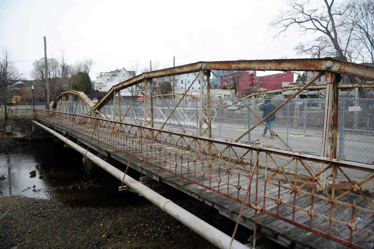 A pedestrian walks across the West Main Street Bridge in Stamford on Jan. 3. The Board of Representatives will vote Monday on an ordinance that urges the mayor to restore the West Main Street Bridge with vehicular traffic.