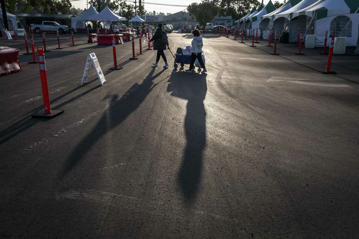 Health care workers depart after finishing up for the day at an authorized coronavirus testing area run by the Santa Clara County Valley Medical Center at the fairgrounds in San Jose. Health officials in San Francisco urged the public to verify the COVID testing site they patronize after fake, unauthorized sites cropped up.