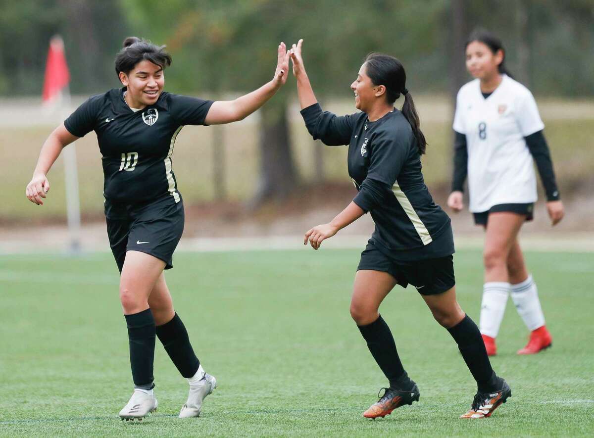 Conroe’s Litzy Garcia (10) gets a high-five from Silvina Salgado (17) after scoring a goal to break a 1-1 tie in the second period of a soccer match during the Lady Highlander Invitational, Friday, Jan. 7, 2022, in The Woodlands.