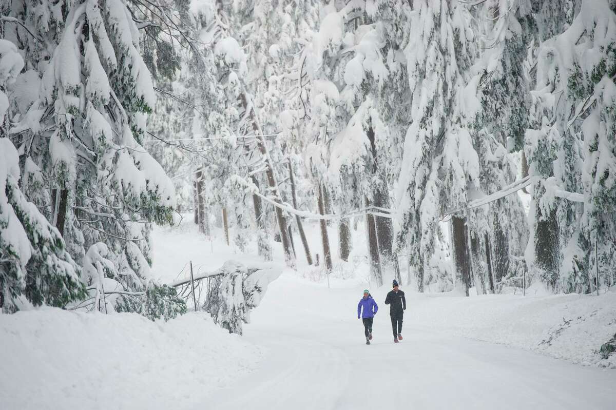 Two runners move along Highway 20 east of Nevada City in December.