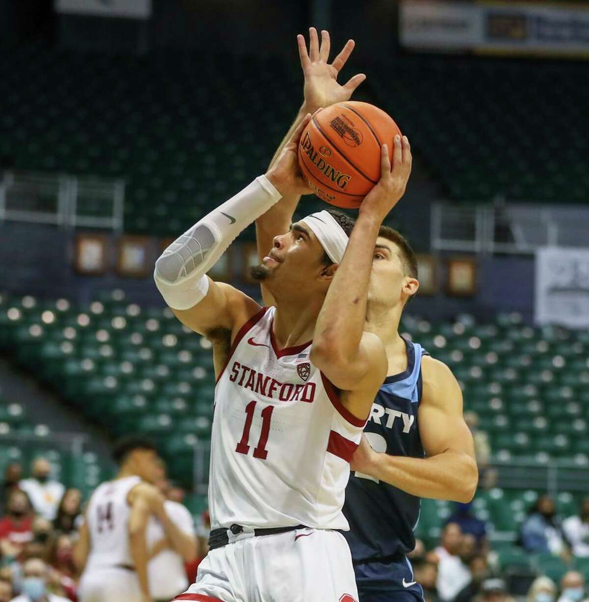 Stanford’s Jaiden Delaire tries to get off a shot during his team’s most recent game, a win over Liberty in Honolulu on Dec. 23. The Cardinal, who have had four games canceled or postponed because of a coronavirus outbreak in their program, are scheduled to resume their season Tuesday with a game against USC at Maples Pavilion.