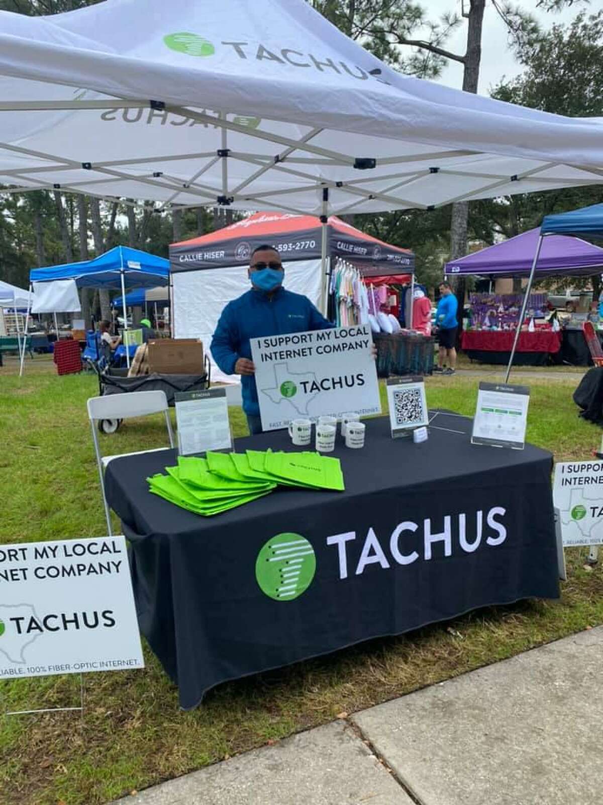 A Tachus representative is set up under a tent enrolling subscribers in the new internet service available in northeast Harris County and Montgomery County.
