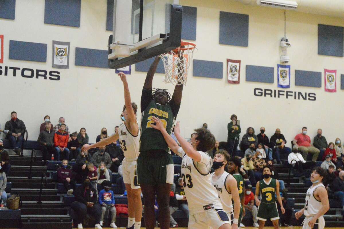 DaMarkus Bean dunks over multiple Father McGivney defenders on Friday night. Bean scored 13 points in the 62-51 win. 