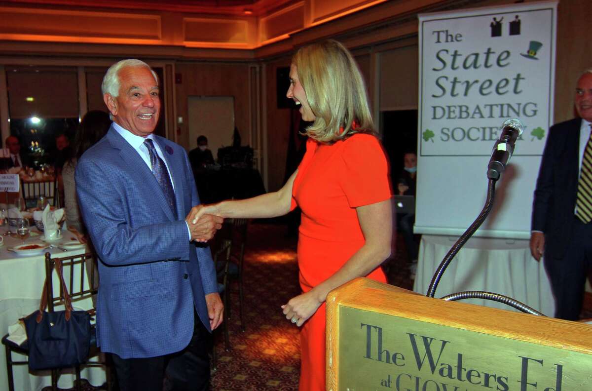 The State Street Debating Society arranged a greeting between Bobby Valentine, left, and Caroline Simmons before the start of the first mayoral candidate debate at The Waters Edge at Giovanni’s in Darien, Conn., on Tuesday Oct. 12, 2021.