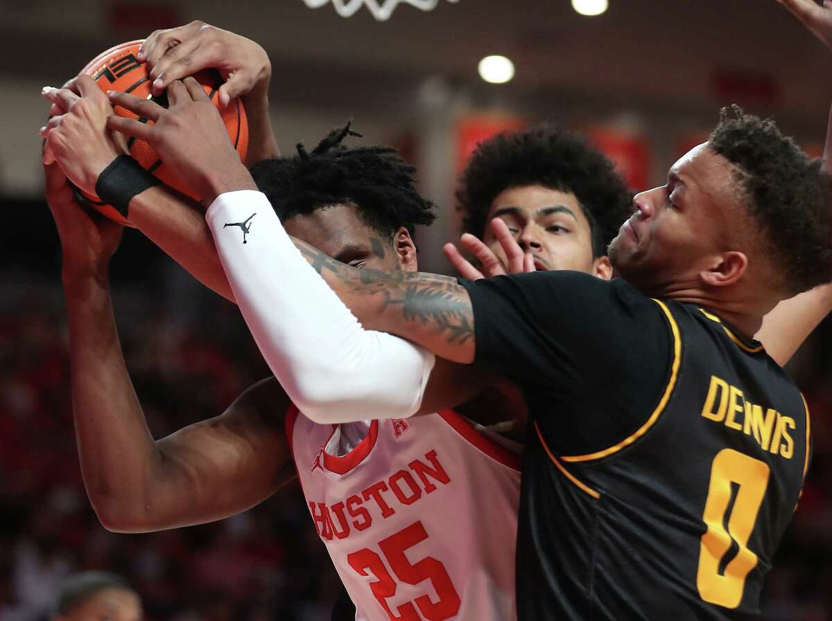 Houston center Josh Carlton (25) fights for a rebound with Wichita State guard Dexter Dennis (0) during the first half on an NCAA basketball game Saturday, Jan. 8, 2022, in Houston.