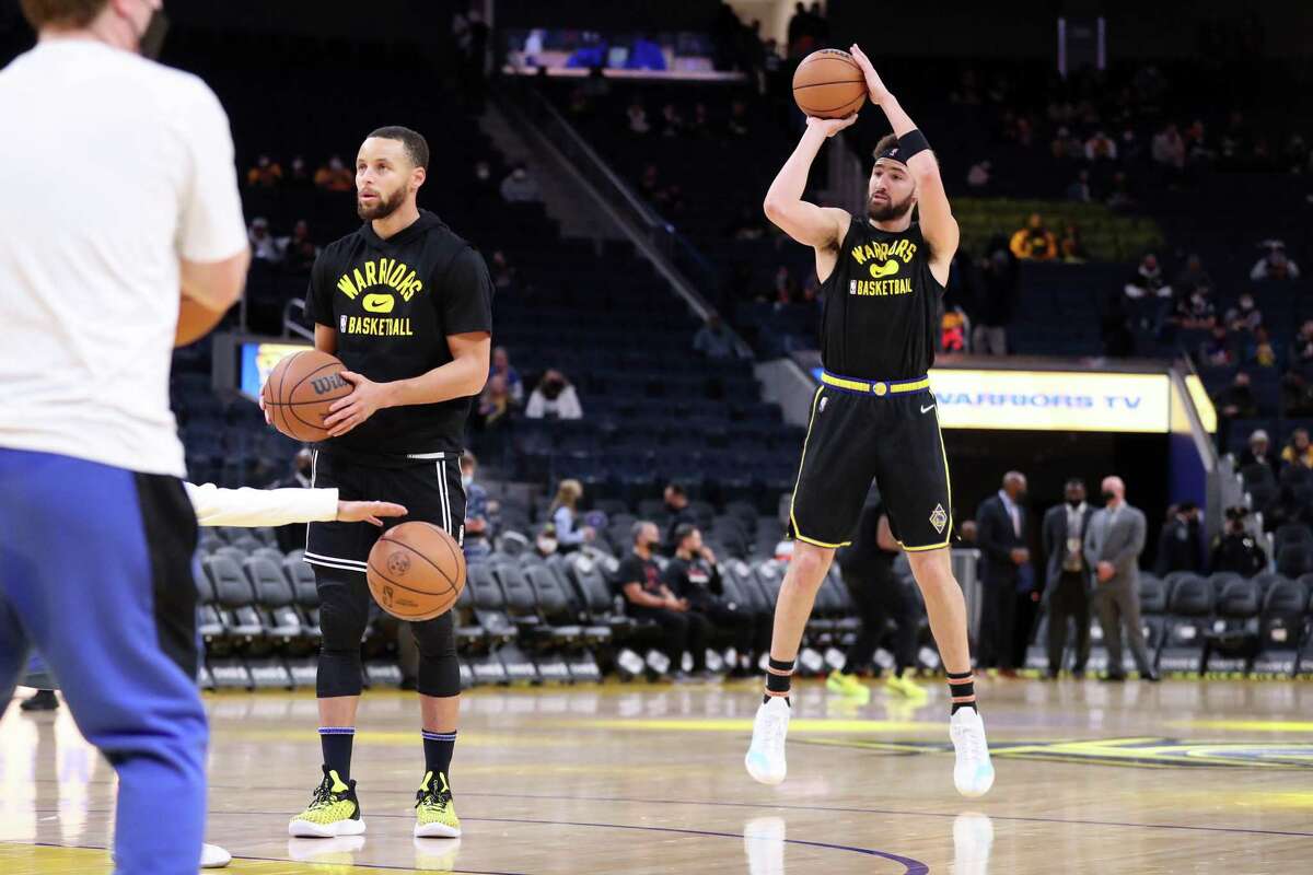 Warriors guards Stephen Curry and Klay Thompson work out before Monday night’s game against Miami at Chase Center.