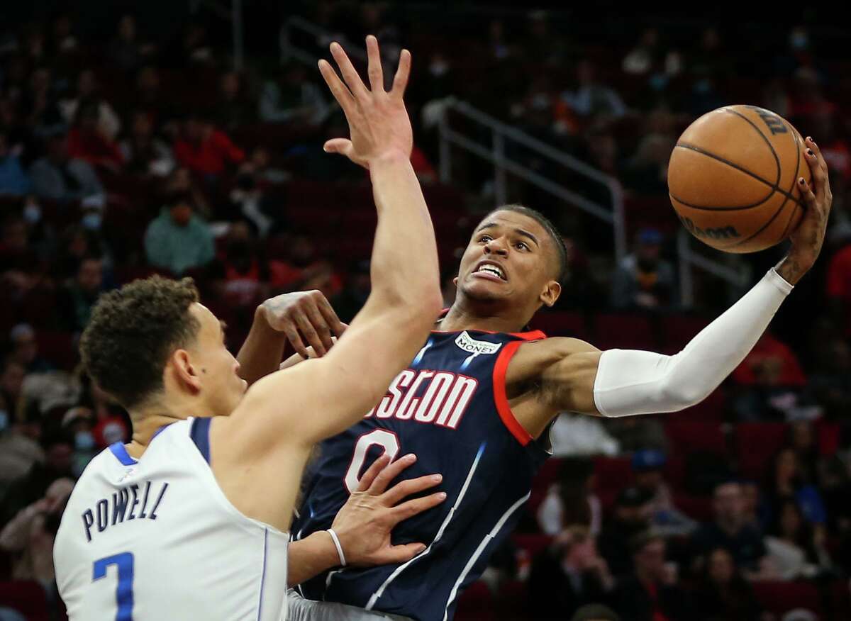 Houston Rockets guard Jalen Green (0) shoots while Dallas Mavericks center Dwight Powell (7) defends during the first quarter of an NBA game Friday, Jan. 7, 2022, at the Toyota Center in Houston.
