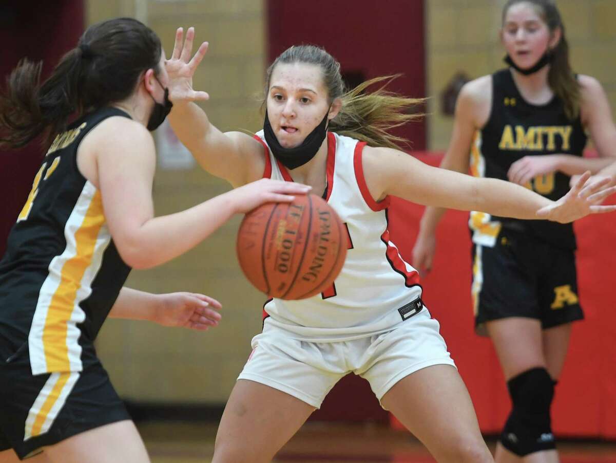 Sacred Heart Academy's Emma Kirck defends the point against Amity's Jayne Whitman during their girls basketball game at Sacred Heart Academyl in Hamden, Conn. on Saturday, January 8, 2021.