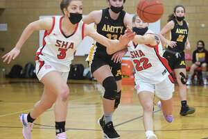 Sacred Heart Academy's Carina Ciampi, left, and Sydney Rossacci pursue a loose ball ahead of Amity's Vivian Cain during their girls basketball game at Sacred Heart Academyl in Hamden, Conn. on Saturday, January 8, 2021.