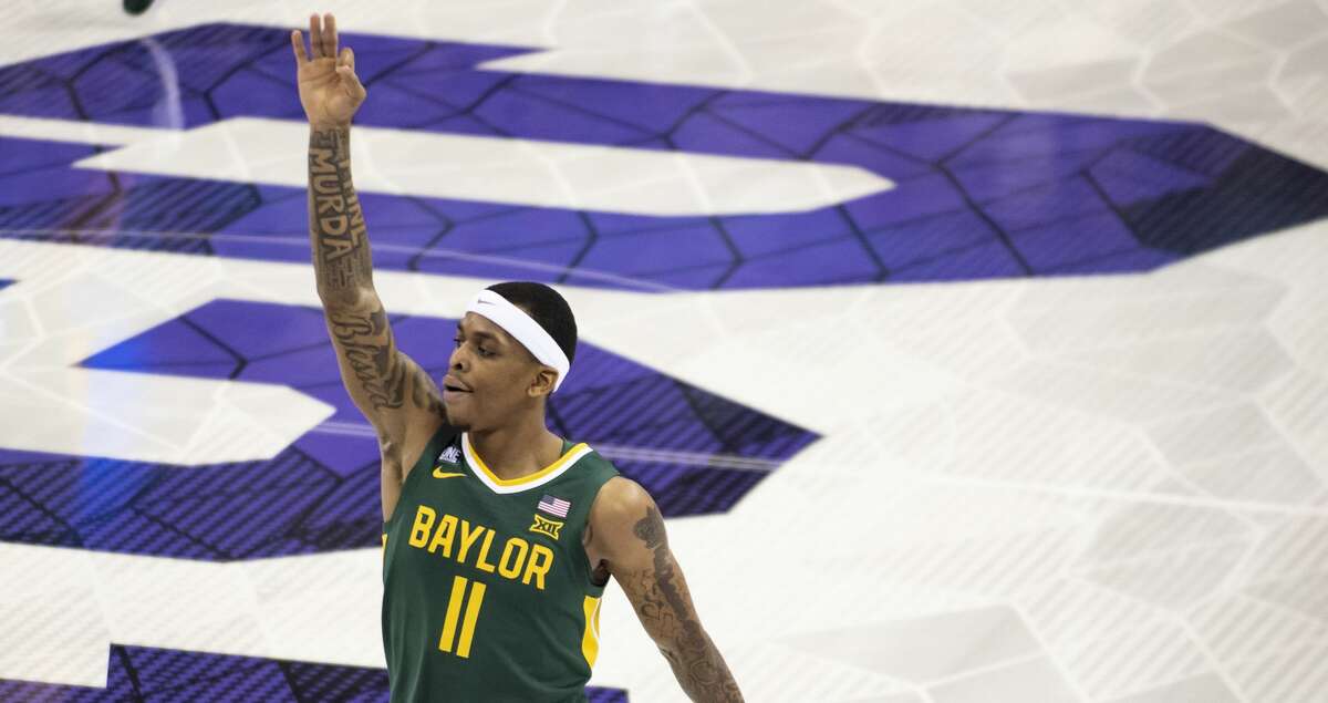 Baylor guard James Akinjo (11) gestures after making a three-point basket in the first half of an NCAA college basketball game against TCU in Fort Worth, Texas, Saturday, Jan. 8, 2022. (AP Photo/Emil Lippe)