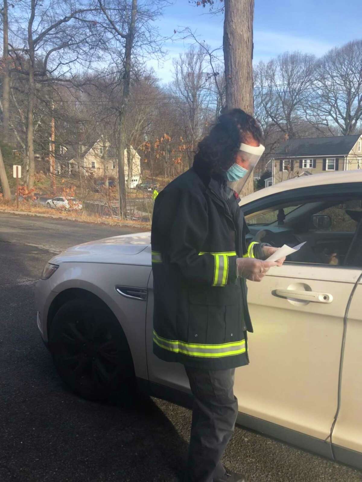 EMT Diana Louw verifies patient details at a Trumbull Emergency Medical Services drive-through test site.