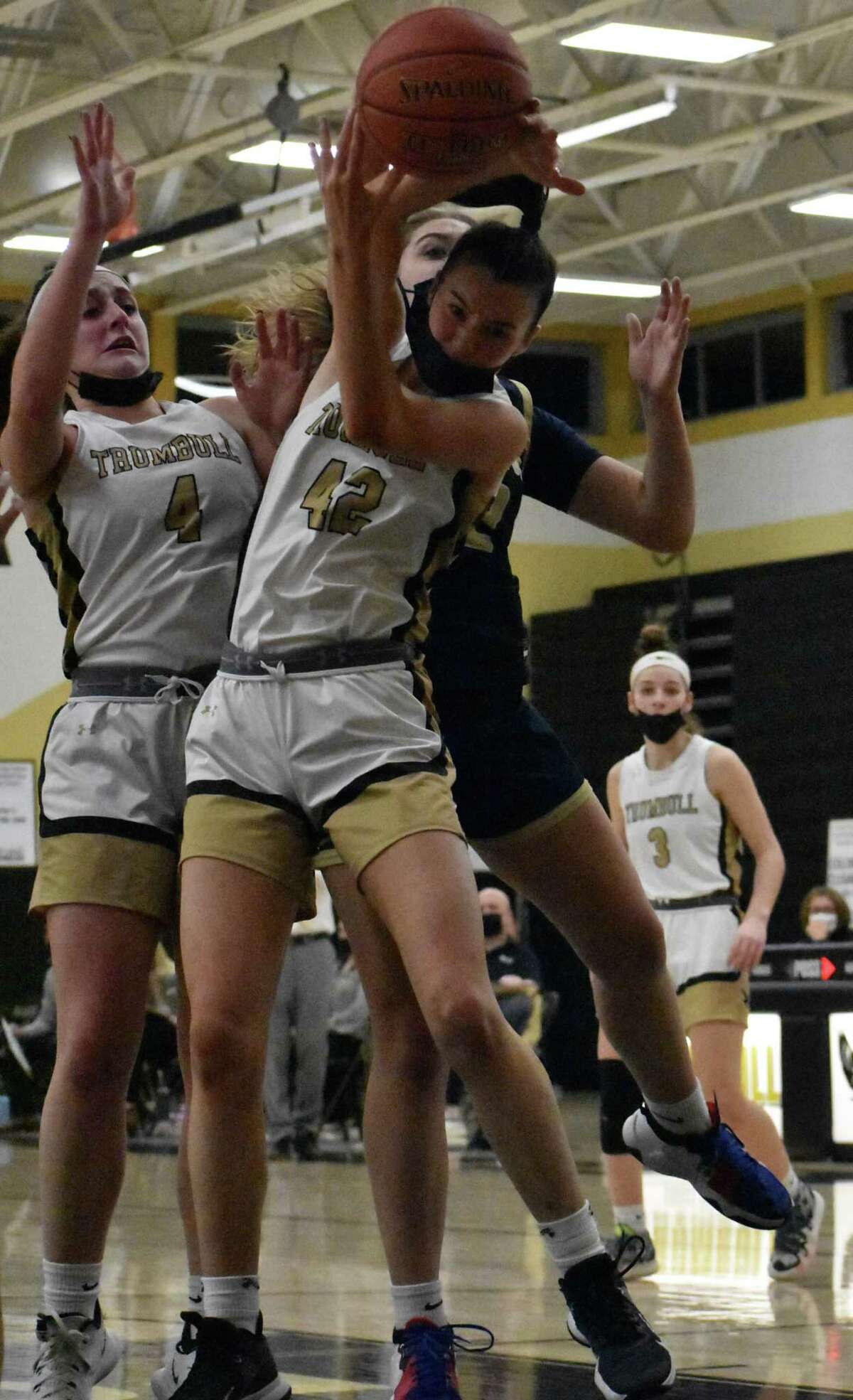 Trumbull's Mary Lynch grabs a rebound during a girls basketball game between Trumbull and Newington at Trumbull High, Trumbull on Saturday, Jan. 8, 2022.