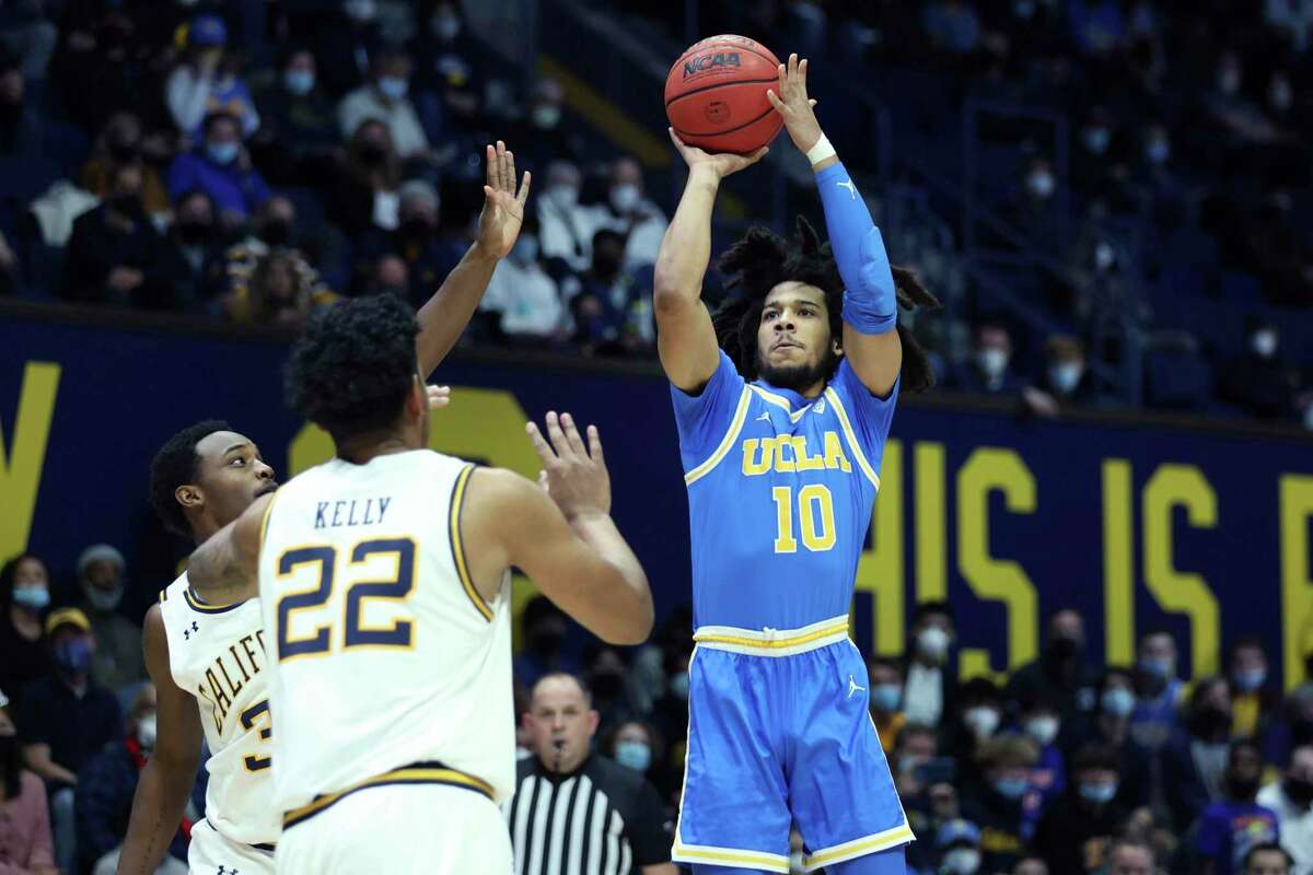 UCLA guard Tyger Campbell (10) shoots against California guard Jalen Celestine (32) and California forward Andre Kelly (22) during the first half of an NCAA college basketball game in Berkeley, Calif., Saturday, Jan. 8, 2022. (AP Photo/Jed Jacobsohn)