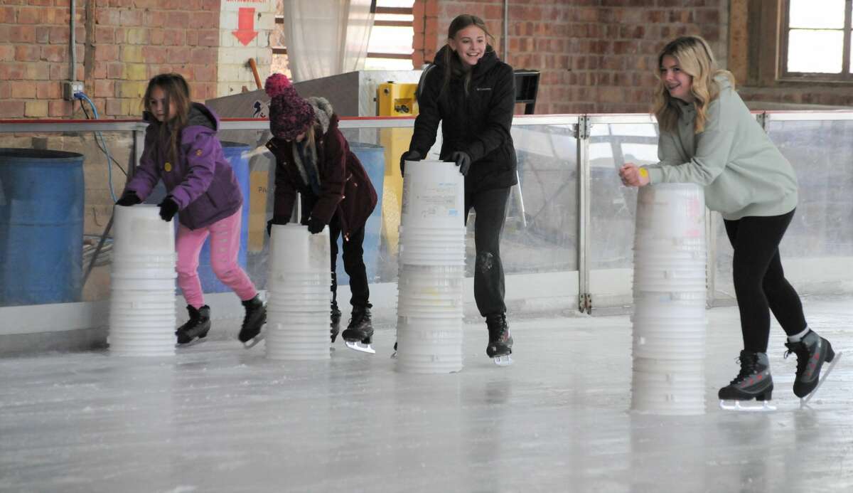 Hayden Raines of Murphysboro, right, joins friends as they cautiously navigate the ice at the Loading Dock in Grafton.