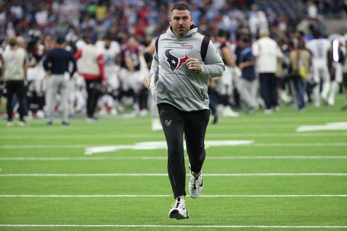 Houston Texans offensive coordinator Tim Kelly runs off the field after the Texans 28-25 loss to the Tennessee Titans in an NFL football game Sunday, Jan. 9, 2022 in Houston.