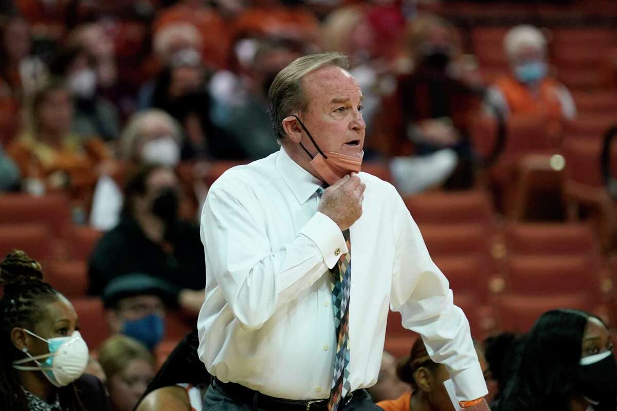 Texas coach Vic Schaefer lowers his mask to talk to players during the team's NCAA college basketball game against Texas Tech, Wednesday, Jan. 5, 2022, in Austin, Texas. (AP Photo/Eric Gay)