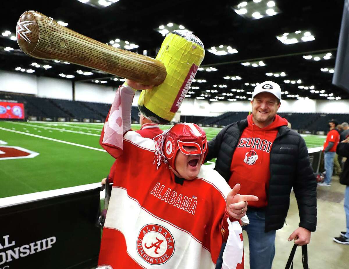 Georgia fan Roy Sherrell gets a kick out of Alabama fan Buck Smith, nicknamed "Nacho Alabamo," during a fan festival at the Indianapolis Convention Center on Sunday.