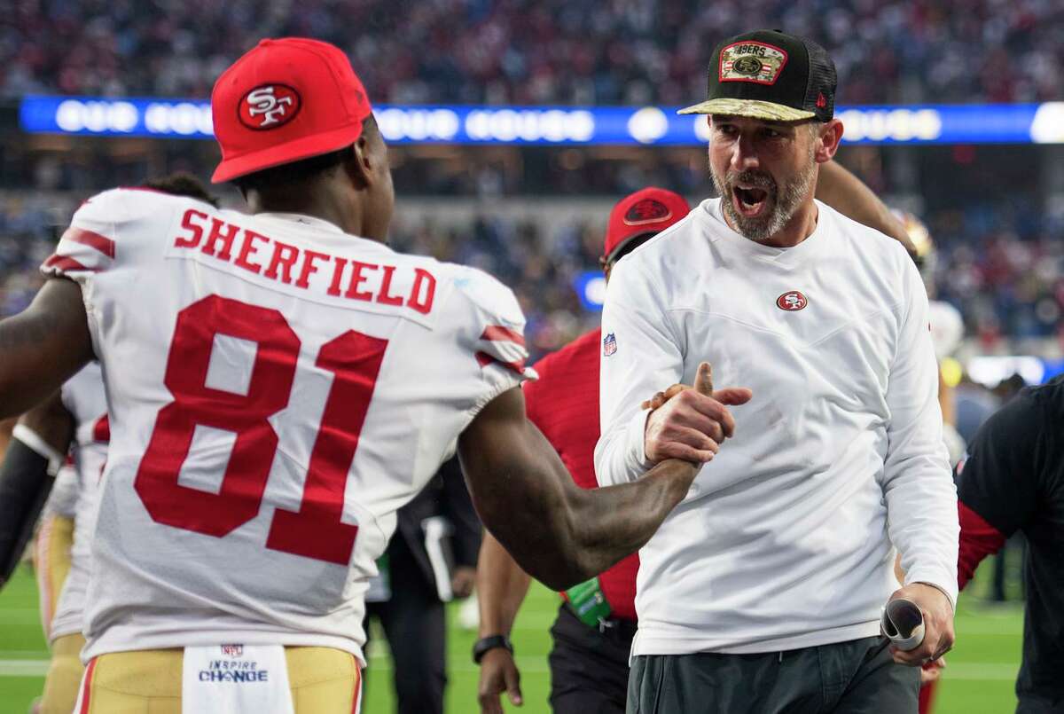 Head coach Kyle Shanahan celebrates the 49ers’ win over the Rams with wide receiver Trent Sherfield. The victory landed San Francisco in the playoffs after a 2-4 start to the season.