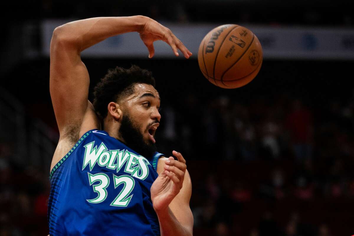 Minnesota Timberwolves center Karl-Anthony Towns (32) makes a pass during the second half of a game against the Houston Rockets at the Toyota Center, Sunday, Jan. 9, 2022, in Houston.