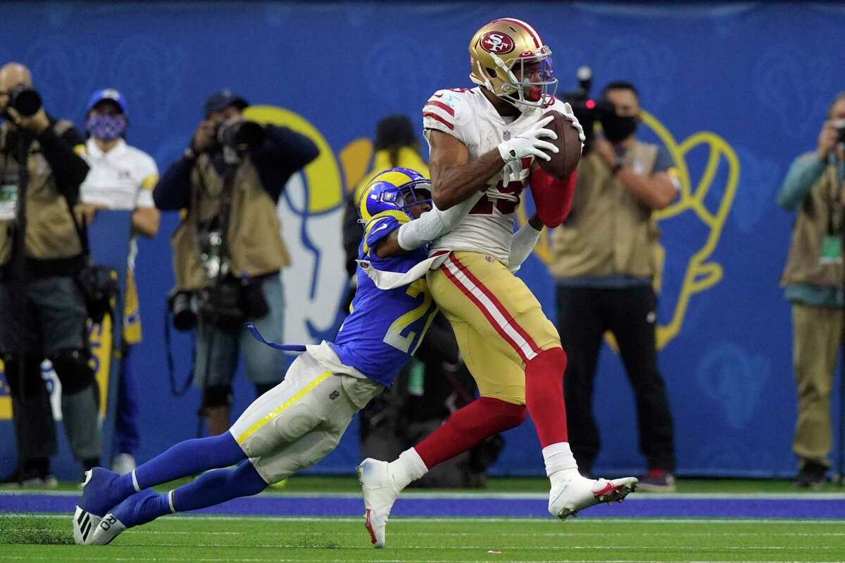 Los Angeles Rams cornerback Donte' Deayon (21) tackles San Francisco 49ers wide receiver Jauan Jennings (15) during overtime of an NFL football game Sunday, Jan. 9, 2022, in Inglewood, Calif. (AP Photo/Mark J. Terrill)