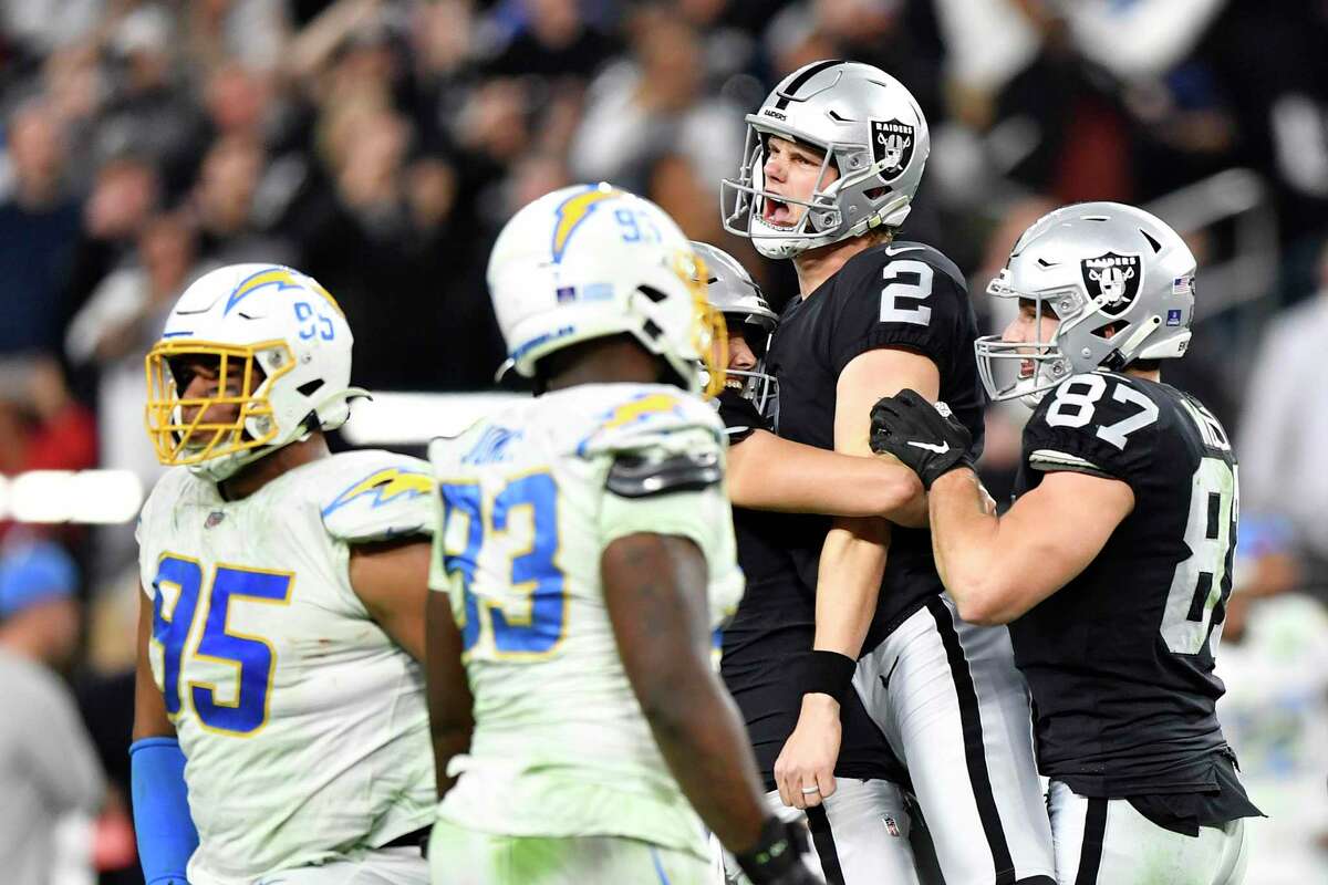 LAS VEGAS, NEVADA - JANUARY 09: Daniel Carlson #2 of the Las Vegas Raiders celebrates after kicking the game-winning field goal against the Los Angeles Chargers during overtime at Allegiant Stadium on January 09, 2022 in Las Vegas, Nevada. (Photo by Chris Unger/Getty Images)