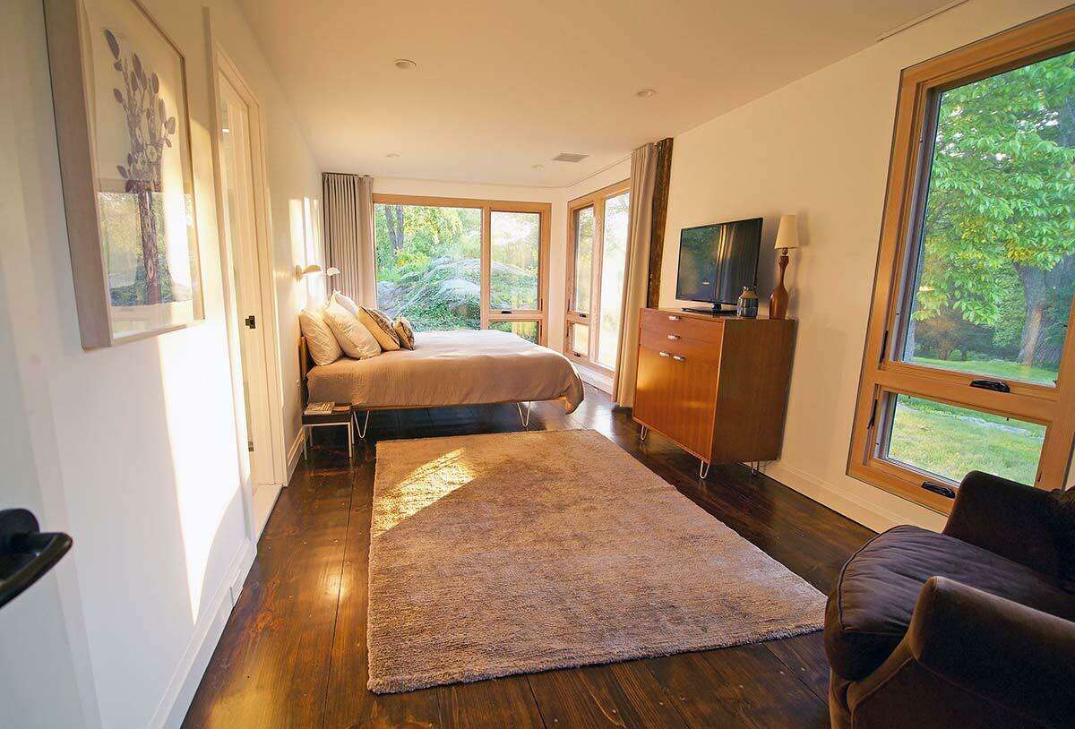 The master bedroom looks out onto a wooded rock formation (popular with bobcats, we’re told).