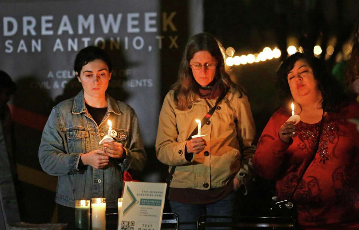 Natalie Lerner, from left, Judith Norman, and Debbie Hernandez are joined in prayer as members of the San Antonio community from different faiths gathered for an interfaith prayer vigil in Main Plaza in 2020.