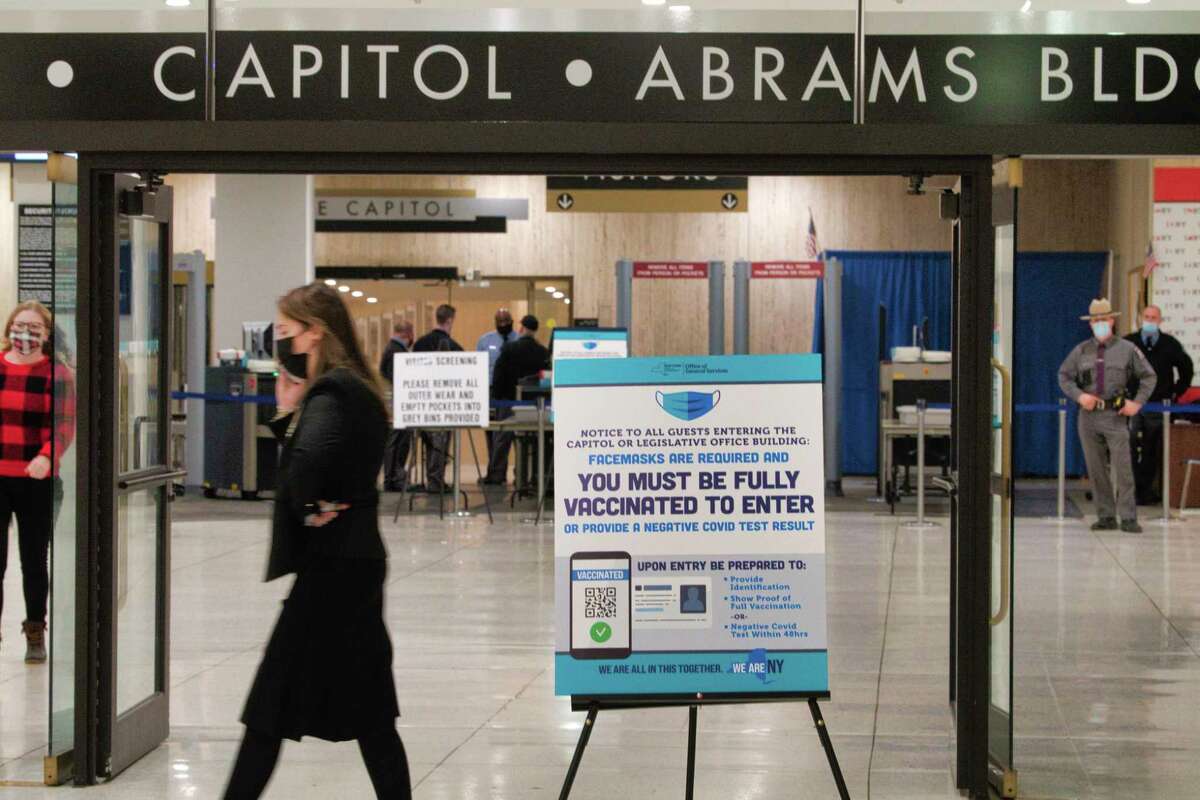 Signs are posted in the concourse level of the Empire State Plaza at the entrance to the Capitol and the Legislative Office Building on Monday, Jan. 10, 2022, in Albany, N.Y.