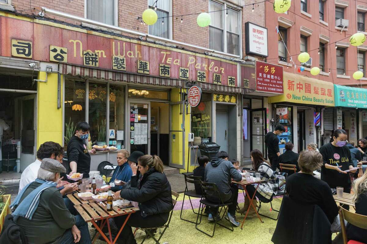 People dine outside Nom Wah Tea Parlor in New York.