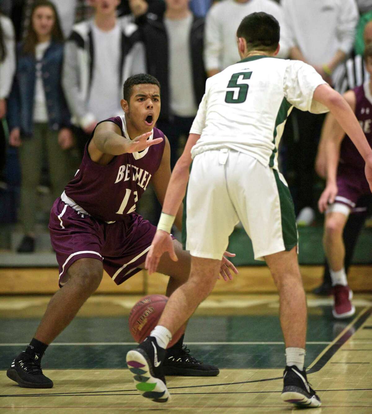 Bethel's Lorenzo Almonte (12) defends New Milford's John Fitzmaurice (5) in the boys basketball game between Bethel and New Milford high schools, Friday night, January 4, 2019, at New Milford High School, New Milford, Conn.