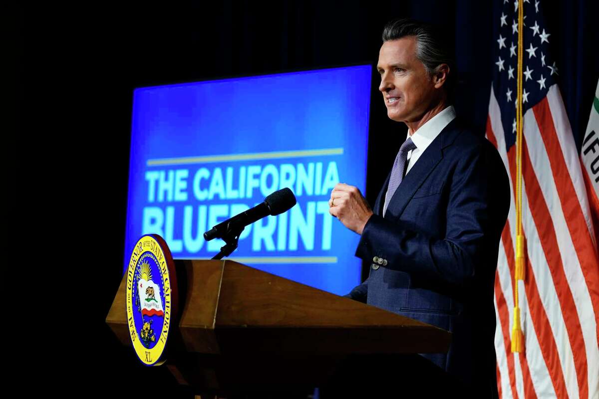 Gov. Gavin Newsom unveils his proposed 2022-23 state budget Monday in Sacramento. He said paid sick leave is a top priority, but the state does not have an active supplemental paid sick leave rule for people who have COVID-19.