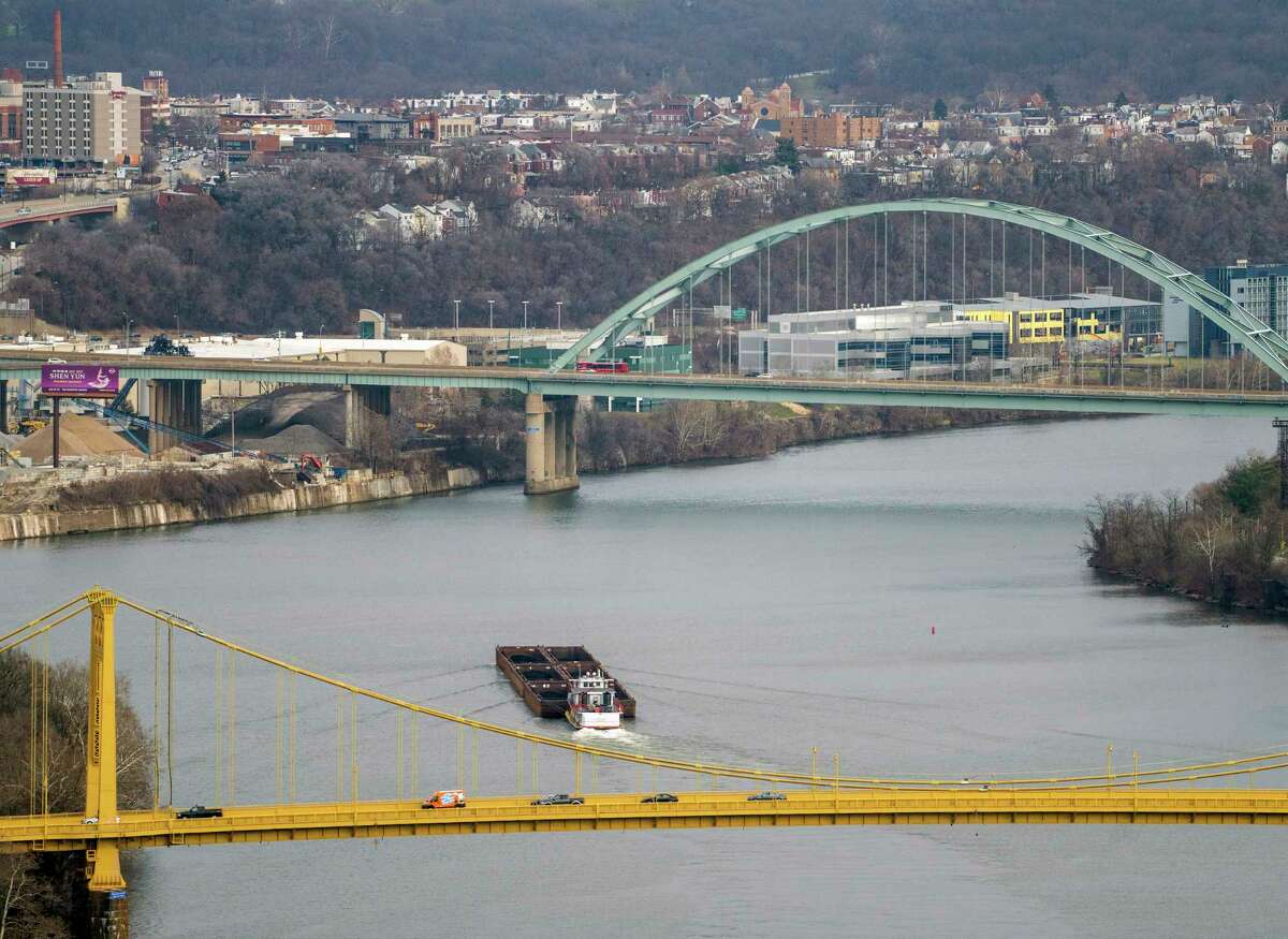 A coal barge headed up the Monongahela River on Thursday, Dec. 23, 2021 in Pittsburgh. (Andrew Rush/Pittsburgh Post-Gazette via AP)