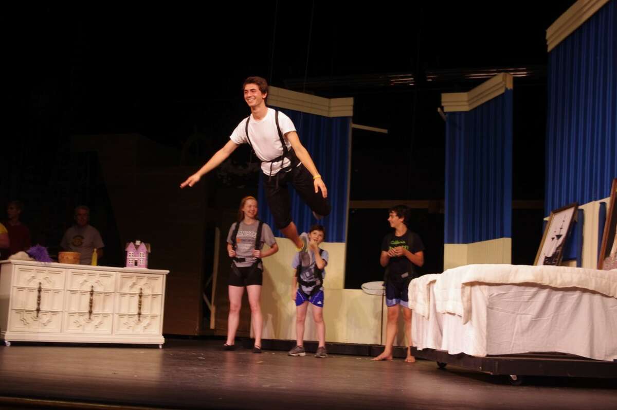 In this file photo from 2013, Thomas Bond, in the title role of the Manistee Civic Players musical “Peter Pan,” flies with the help of trapeze equipment installed at the Ramsdell Theatre by a Louisville, Kentucky company. A summer musical can cost the Civic Players around $12,000 to produce, due to royalty costs, sound equipment and, on rare occasions, flying equipment.