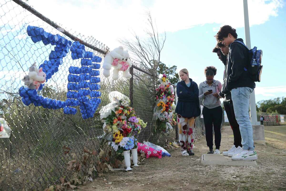 Students gather Monday, Jan. 10, 2022, at a memorial near Johnson High School where two students were killed in a crash on Saturday.