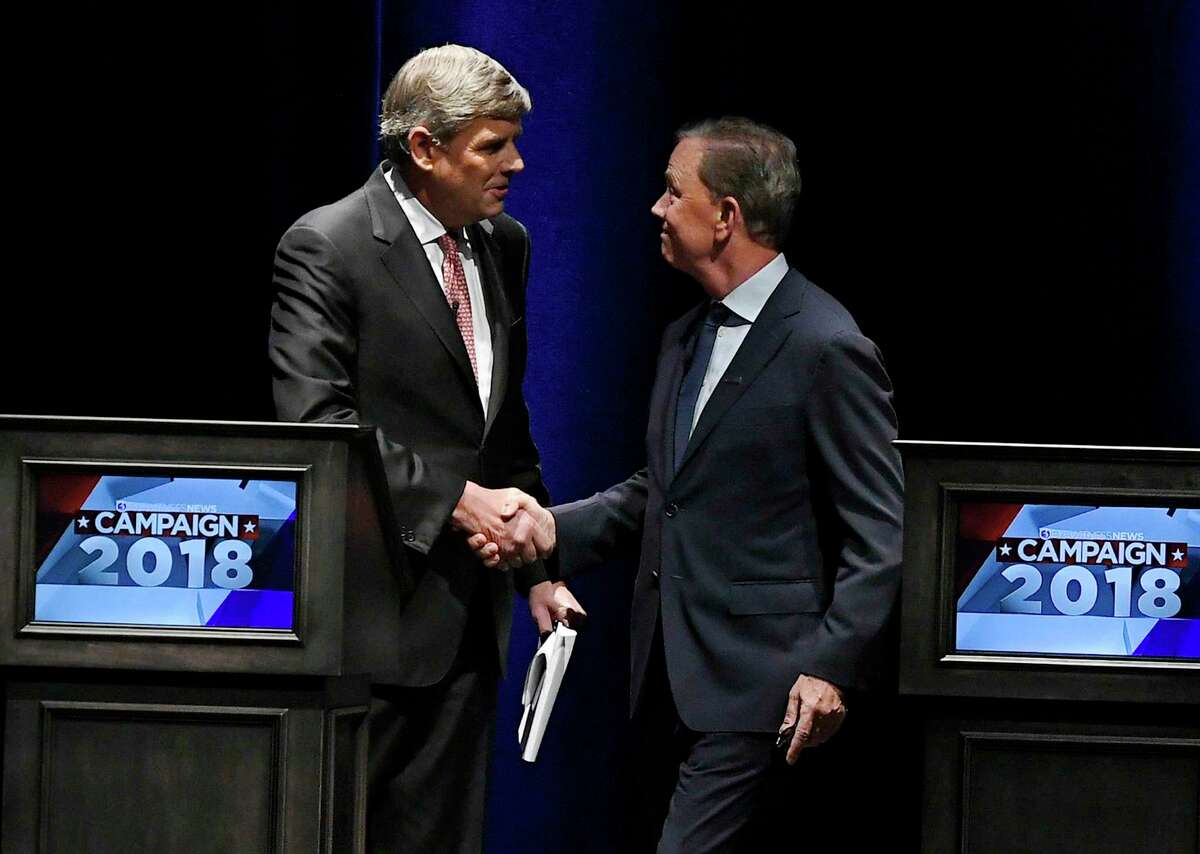 Republican Party candidate Bob Stefanowski, left, shakes hands with Democratic Party candidate Ned Lamont, at the end of a gubernatorial debate at the University of Connecticut in Storrs, Conn., Wednesday, Sept. 26, 2018. (AP Photo/Jessica Hill)