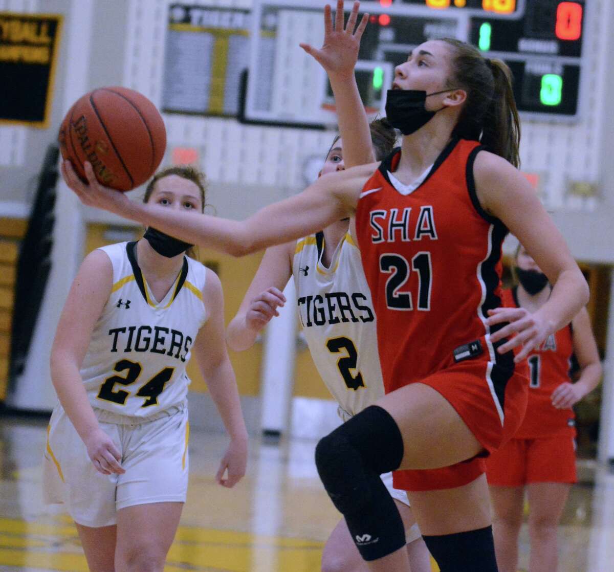 Rosa Rizzitelli of Sacred Heart Academy makes a scoop shot as Coco Rourke of Hand looks on during the Tigers' 39-36 win Monday night.