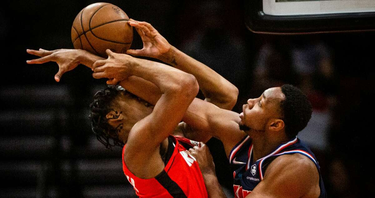 Houston Rockets guard Josh Christopher (9) gets blocked by Philadelphia 76ers center Charles Bassey (23) muring a game at the Toyota Center, Monday, Jan. 10, 2022, in Houston. Philadelphia 76ers won 111-91 against the Houston Rockets.