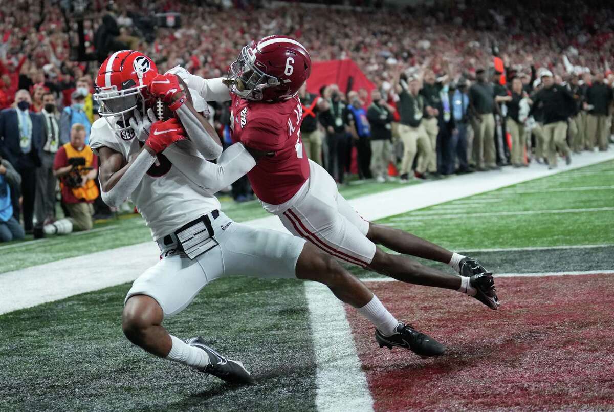 Georgia wide receiver Adonai Mitchell (5) scores a touchdown against Alabama defensive back Khyree Jackson (6) in the fourth quarter of the College Football Playoff championship football game against Alabama in Indianapolis on Monday, Jan. 10, 2022. (AJ Mast/The New York Times)
