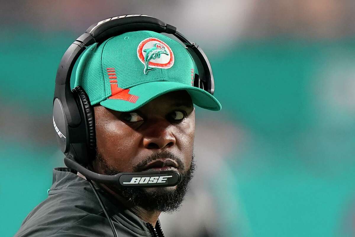 Miami Dolphins head coach Brian Flores guides his team from the sideline during the second half of an NFL football game against the New England Patriots, Sunday, Jan. 9, 2022, in Miami Gardens, Fla.