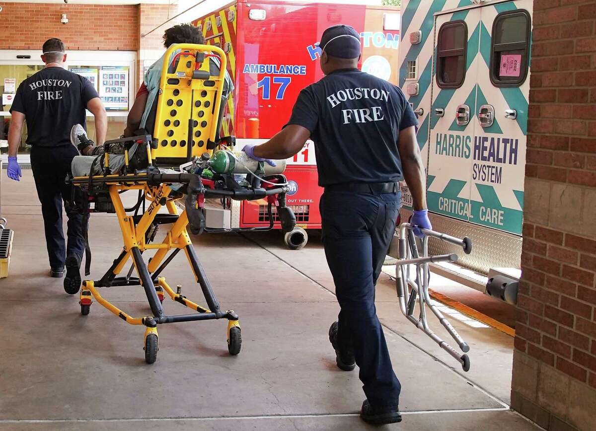 Houston Fire Dept. paramedics Valentin "Beau" Beauliere, right, and Josh Walls push past other ambulances as they take a patient to Ben Taub Hospital on Thursday, Aug. 19, 2021.