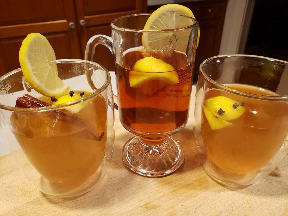 A trio of cozy hot toddies (l to r) rum and cinnamon; cranberry tea and brandy; bourbon and clove with an extra dash of lemon.  