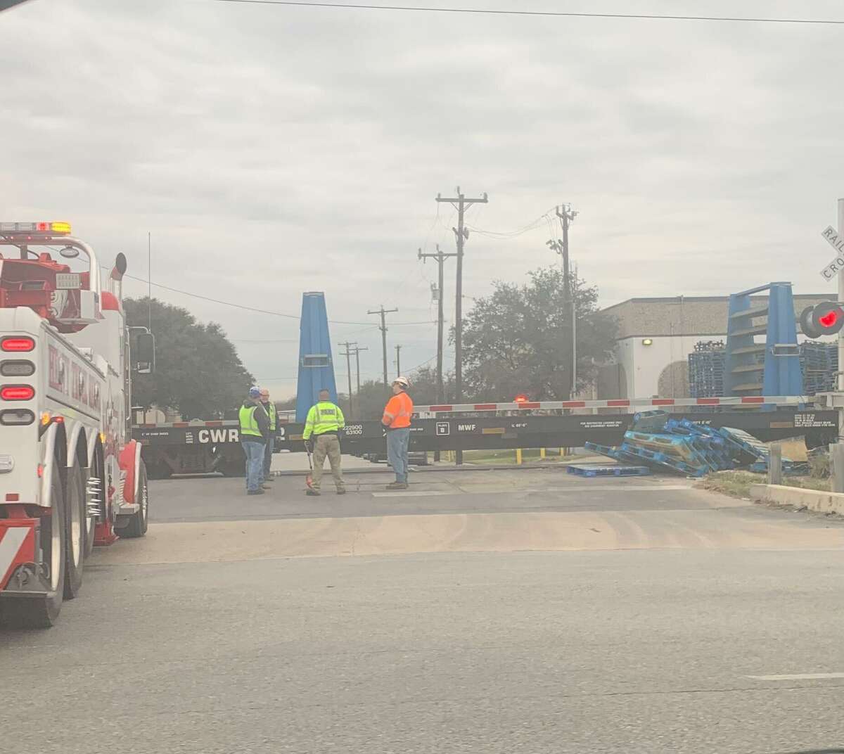 Workers sort out the scene where a train traveling parallel to Interstate 35 struck an 18-wheeler that was crossing the tracks at Rittiman Road on Tuesday, Jan. 11, 2022. No one was injured.