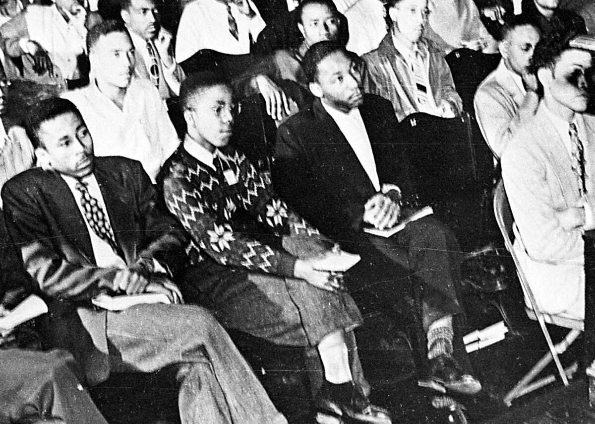 FILE - In this 1948 file photo, Martin Luther King, Jr., third from left, listens to a speaker during an assembly at Morehouse College in Atlanta. As a teenager in 1944, King worked on a tobacco farm in Connecticut. That experience influenced his decision to become a minister. 