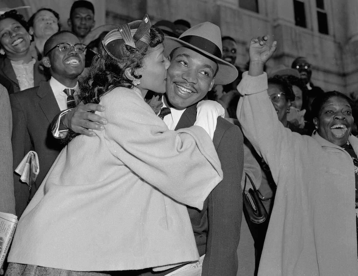 The Rev. Martin Luther King Jr. is welcomed with a kiss by his wife Coretta after leaving court in Montgomery, Ala., March 22, 1956. King was found guilty of conspiracy to boycott city buses in a campaign to desegregate the bus system, but a judge suspended his $500 fine pending appeal. 