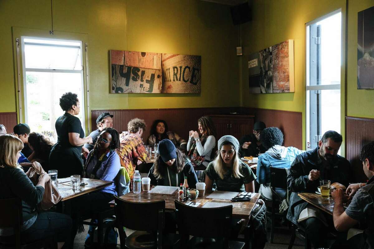 People crowd into the original Brown Sugar Kitchen for lunch in West Oakland.