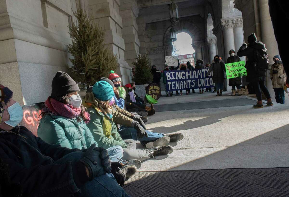 People brave the frigid temperature to protest eviction outside the New York State Capitol on Tuesday, Jan. 11, 2022 in Albany, N.Y.