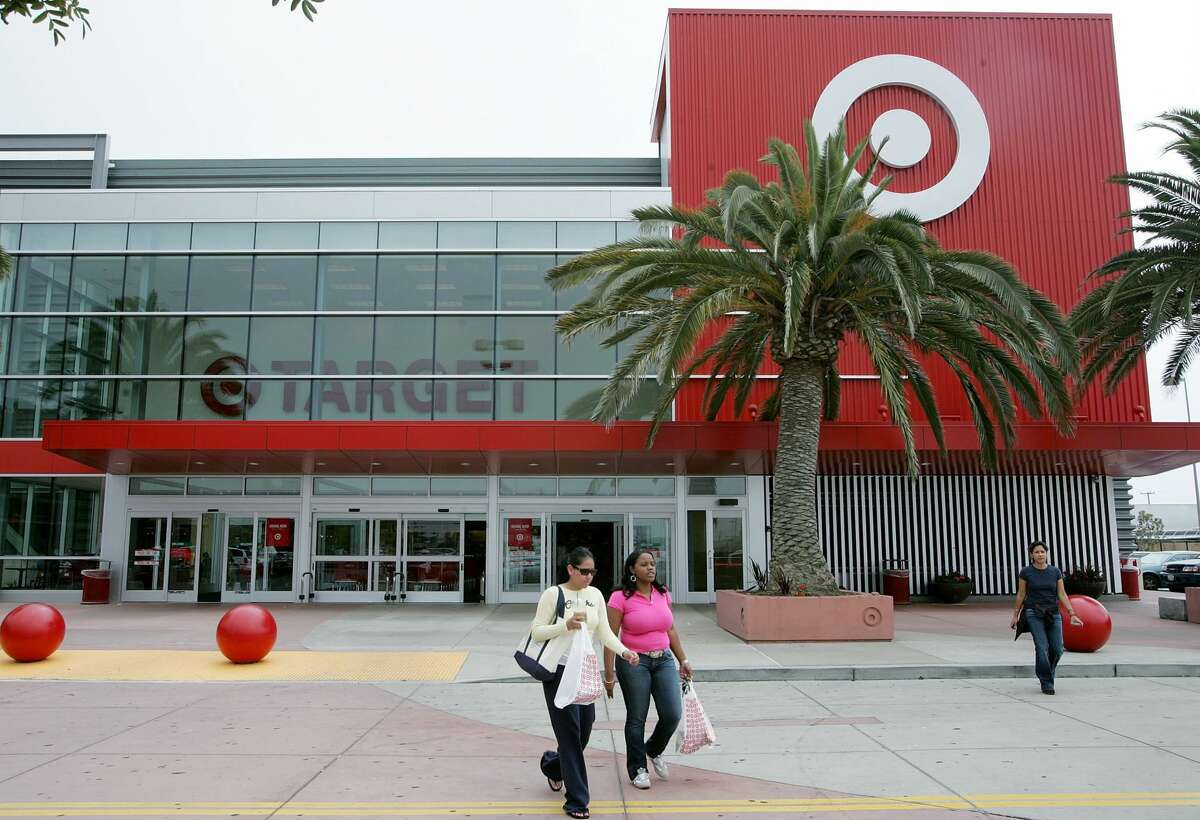 Customers carry bags as they leave a Target store in Albany. 