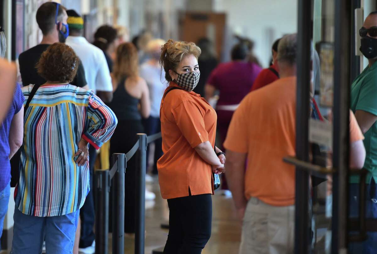 Election staff and volunteers wait in line to be tested for COVID-19 in November 2020 at the Bexar County Elections Department. Over 900 election workers and volunteers were being tested after the presidential election that year. County officials said the pandemic remains a concern in the upcoming March 1 primary, with early voting set to start Feb. 14.